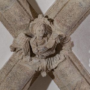 Keystone of an angel holding the moon in the Crypt of the Portico of Glory